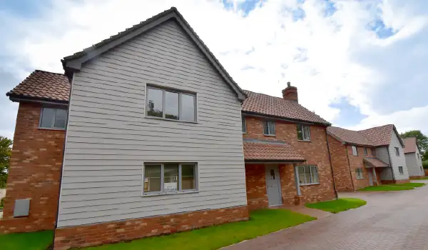 Line up of several new-build homes in Stonham Aspal, Suffolk with the installation of light grey Cortizo aluminium windows and doors.