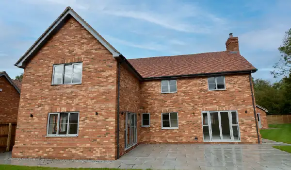 Large 5 bedroom new-build property in a new development in Stonham Aspal, Suffolk. Showcasing the rear exterior view of light grey Cortizo aluminium windows and doors.