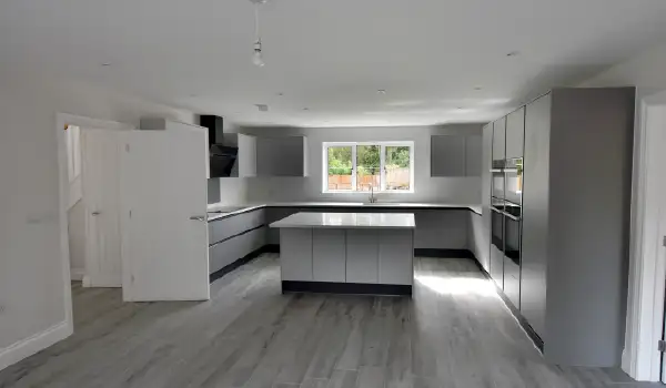 Kitchen layout with island interior view of a Coritzo aluminium window lighting up the room.